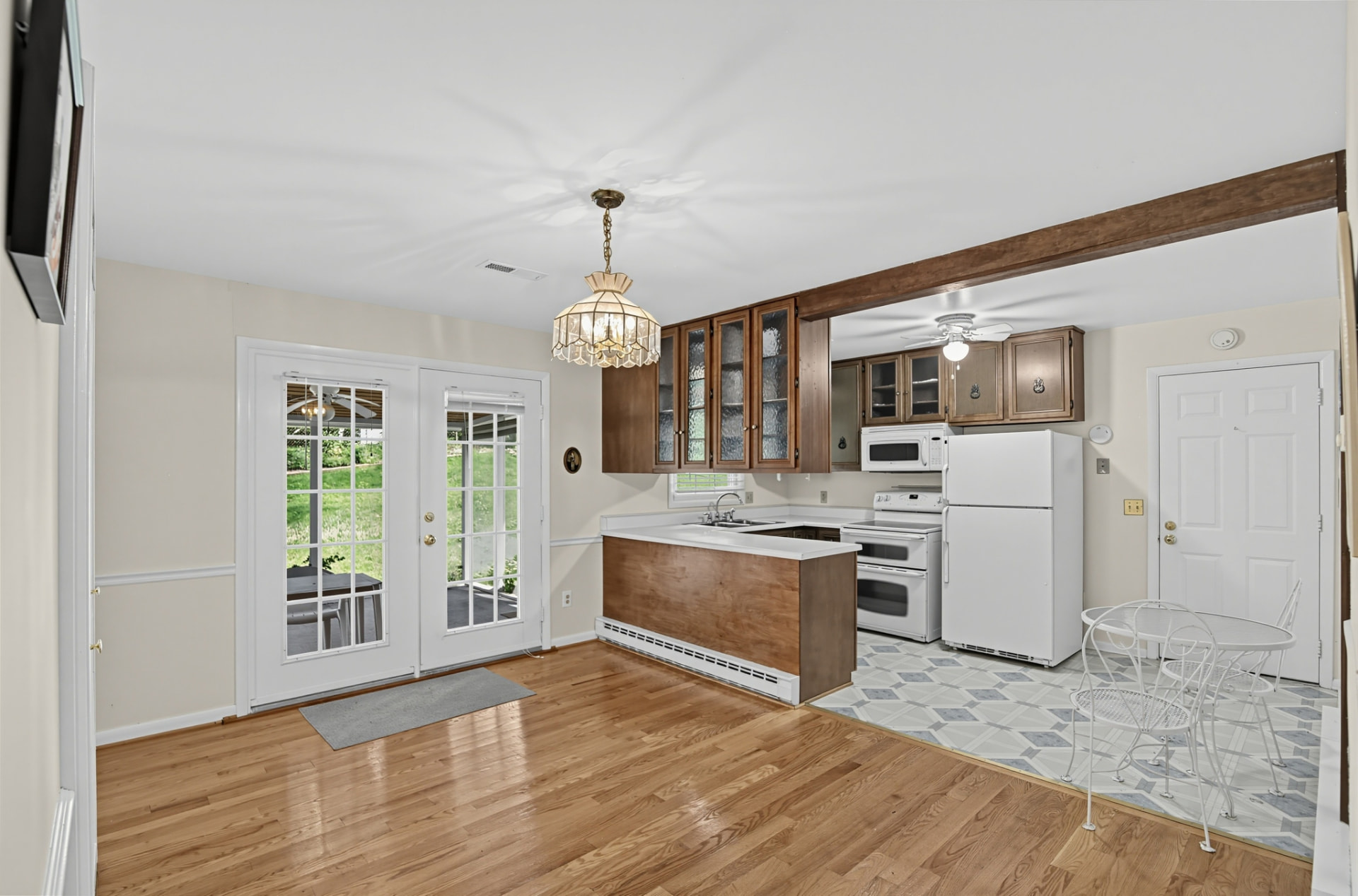 Eat-in kitchen with French doors to the screened porch and a breakfast table