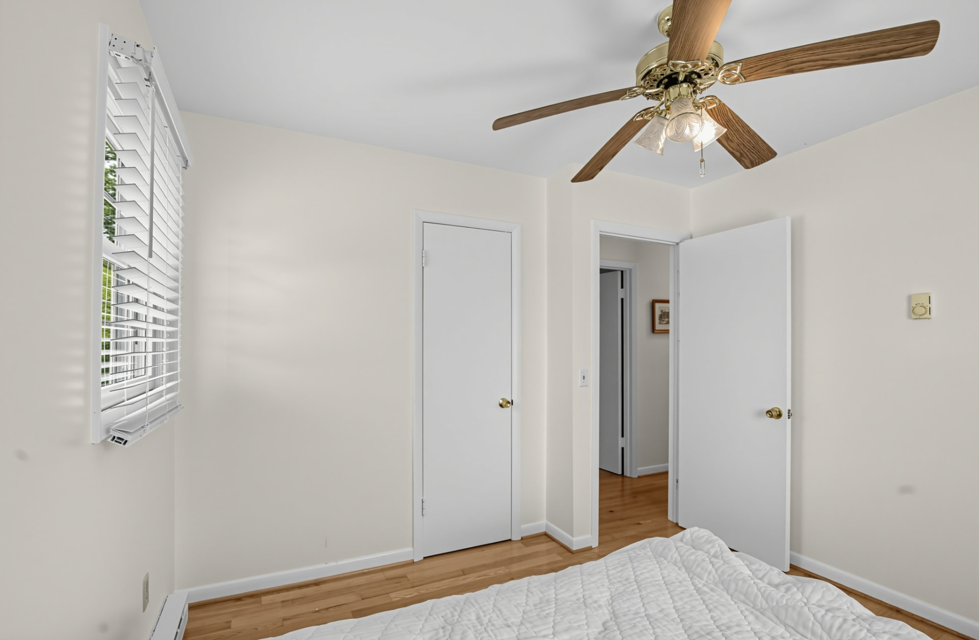 Bedroom with hardwood floors, closet and natural light