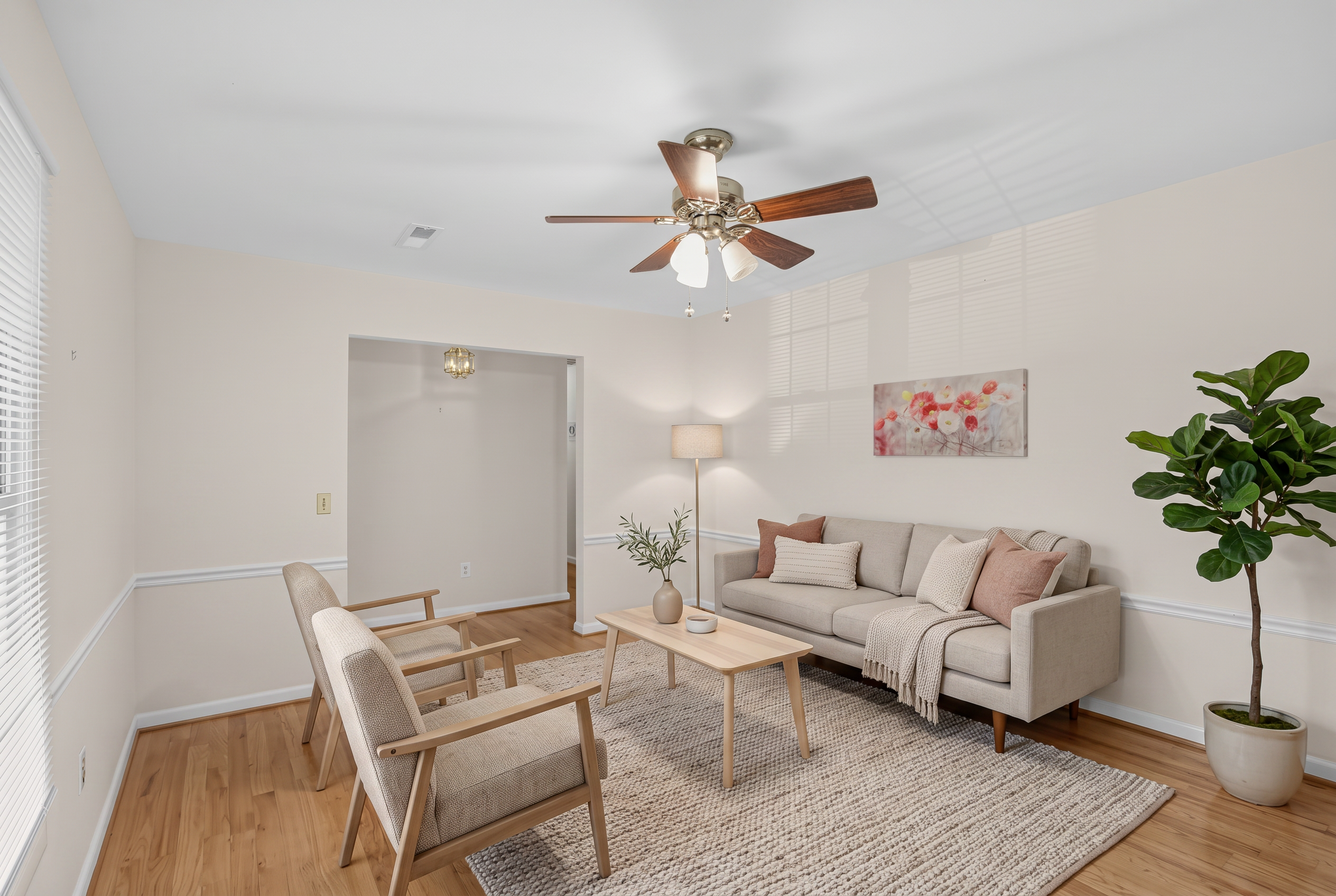 Virtually staged living room with sofa, chairs, and rug